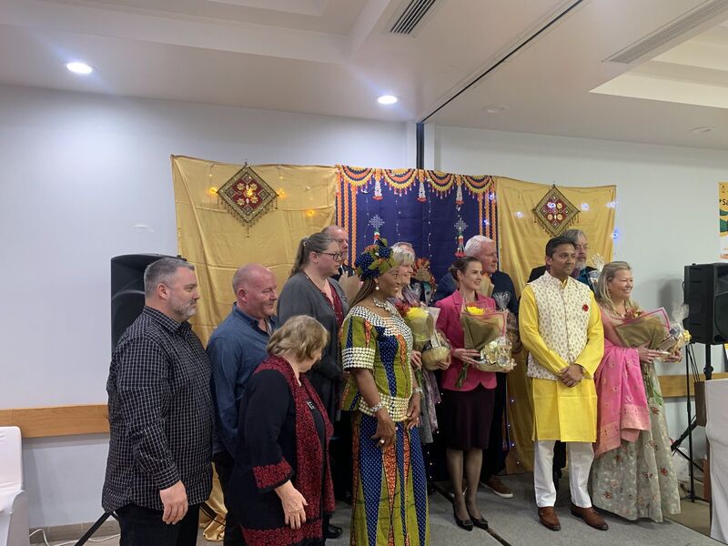 Fred Drodge with community members in traditional dress at a celebration