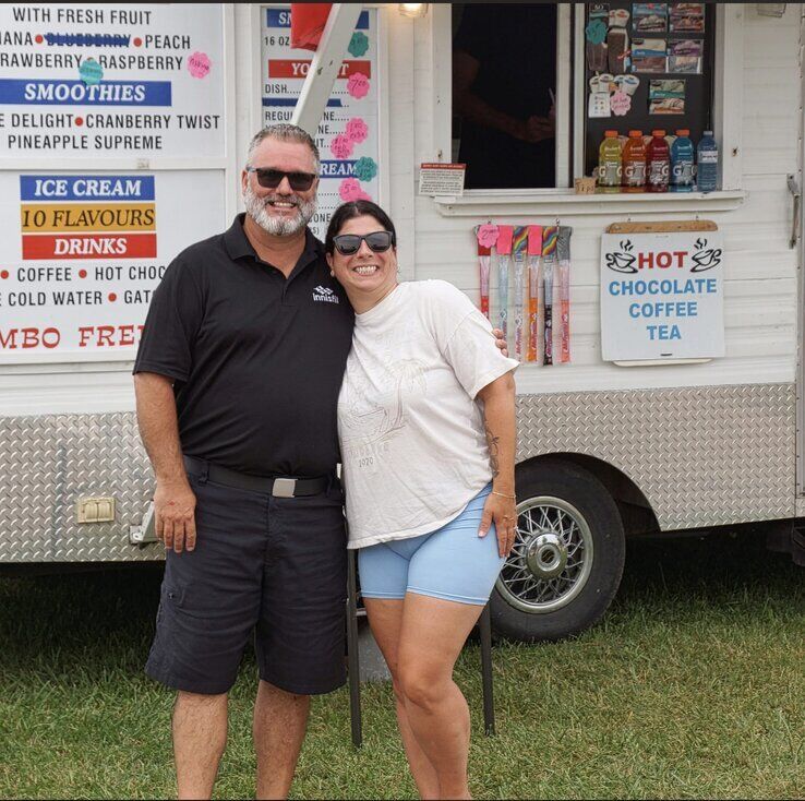 Fred Drodge and a companion in front of a food truck