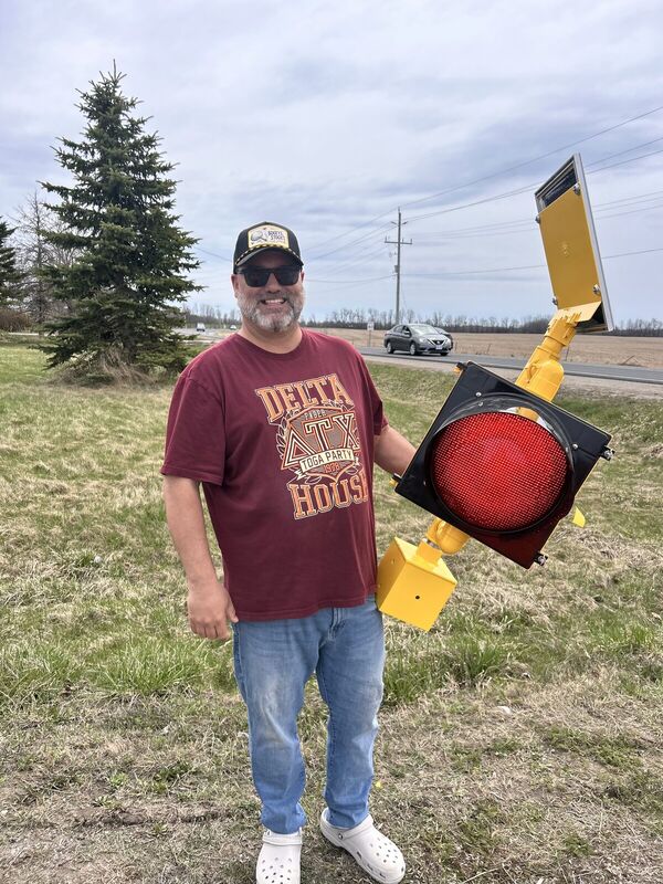 Fred Drodge holding a retired traffic signal head